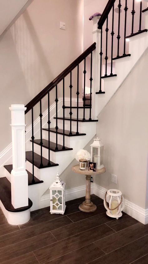 Stair case decor Floor lanterns  Round table  Staircase  Floral Floor Lanterns Decor Entryway, Decorating Candles Ideas, Floor Lanterns Decor, Floor Lanterns, Staircase Decor, Lantern Candle Decor, Stair Remodel, Hallway Designs, Staircase Railings