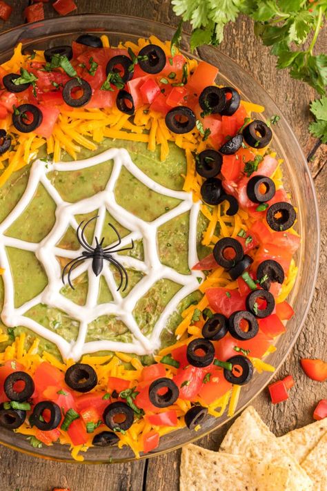 This spiderweb taco dip is layered with refried beans, a mixture of cream cheese, sour cream, and taco seasoning, then topped with guacamole, a creepy piped web, and lots of taco dip fixins. Spider Web Taco Dip, Halloween Taco Dip, Halloween Dip, Pineapple Dream Dessert, Layered Bean Dip, Recipe Inspirations, Halloween Party Appetizers, Sour Cream Dip, Halloween Food Appetizers