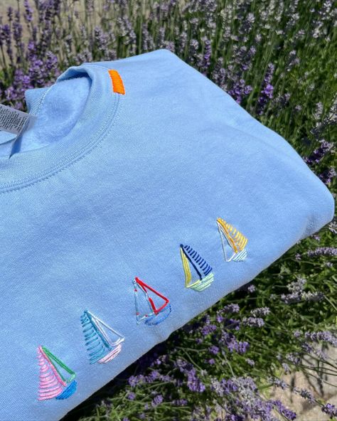 newest edition: sailboats! a fun custom piece for a special someone @haydenbrennen ⛵️🤭🩵🐚🐟🐠 #stitchiesbyag #toronto #custom #handstitched #fyp #pinterest #uniquesweatshirts #customclothing #customdesign #design #clothing #sweatshirt #crewneck #summer #ocean #microinfluencer Patchwork Crewneck Ideas, Patch Sweatshirt Diy, Sailboat Embroidery, Beach Embroidery, Crewneck Embroidery, Patchwork Hoodie, Clothes Embroidery Diy, Patchwork Sweatshirt, Summer Ocean