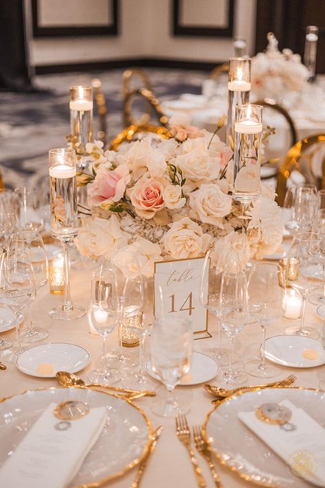 Alexa and Rami’s wedding showcased a glamorous white and gold design with blush accents. The reception featured dramatic table centerpieces included a mix of crystal and white floral bridges, lush floral table runners & tall candle towers. | Floral, Decor, Production & Design: Royal Luxury Events / Photo: Nate Messarra Photography | wedding table centerpieces, low floral arrangements, wedding reception decor, pink wedding flowers, elegant, wedding candles, floating candles, wedding inspiration Wedding Flowers Elegant, Elegant Wedding Centerpieces, Gold And Blush Wedding, Dramatic Table, Blush Design, Floating Candles Wedding, Elegant Wedding Centerpiece, Candles Wedding, Floral Table Runner