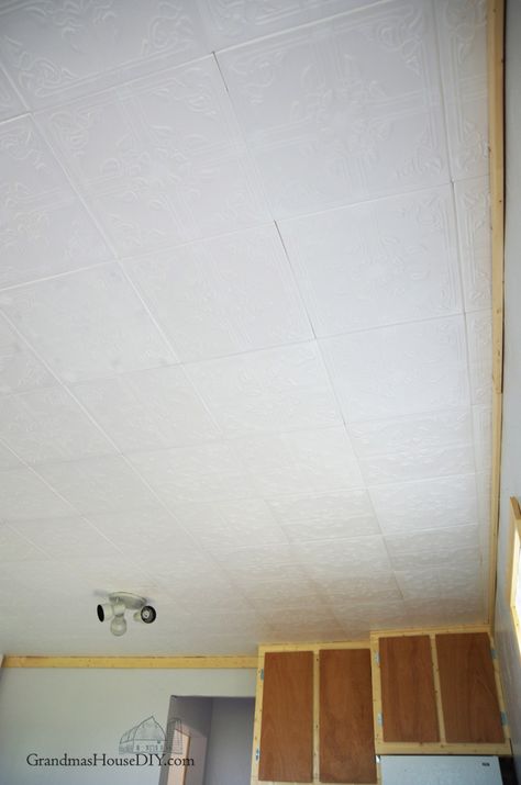 Easy to install Styrofoam do it yourself ceiling tiles over an ugly ceiling, how to Covering Ceiling Tiles, Ceiling Tile Replacement Ideas, How To Cover Ceiling Tiles, Styrofoam Ceiling Tiles Ideas, Painting Ceiling Tiles, Ceiling Tiles Diy, Basement Ceiling Insulation, Basement Window Replacement, Basement Ceiling Ideas Cheap