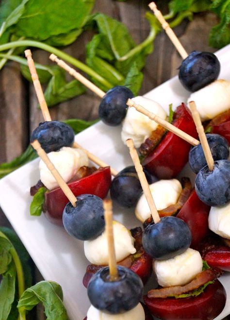 Mini Fruit Skewers Recipe can be made ahead and are the perfect 4th of July appetizer! Fresh, festive and fun, they are over-the-top delicious and great for any outdoor barbecue or summer party. #redwhiteandblue #july4th #skewers #kebabs #bacon #blueberries #cherries #mozzarella #appetizers Purple Party Food, Blueberry Skewers, Purple Party Foods, Appetizers On A Stick, Summer Buffet, Mozzarella Appetizers, 4th Of July Food Ideas, July Food Ideas, Mozzarella Stick