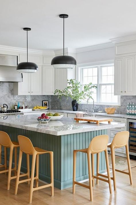 Kitchen features a green beadboard kitchen island with marble countertop and modern beige stools lit by modern black lanterns and white cabinets with nickel pulls. Beadboard And Wallpaper, Beadboard Kitchen Island, Green Beadboard, Wood Beadboard, Nola House, Beadboard Kitchen, Island Makeover, Powder Room Renovation, Beadboard Wallpaper