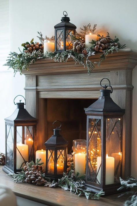 Use varied lanterns filled with candles or lights for warm and inviting fireplace Christmas decorations. Click here for lantern styling tips. Mantle Lantern Decor, Lanterns In Front Of Fireplace, Lantern In Fireplace, Lanterns On Fireplace Hearth, Plants On Fireplace Hearth, Large Lantern Decor Ideas Fireplace, Fireplace Winter Decor, Lantern Decor Fireplace, Stage Fireplace