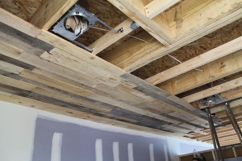 As you know, we’ve been working on disassembling pallets off and on for quite some time now.  We’ve finally started installing some of the pallet ceiling.  We haven’t done too muc… Pallet Roof, Basement Ceiling Ideas Cheap, Wooden Pallet Crafts, Pallet Ceiling, Roof Ideas, Diy Basement, Basement Makeover, Basement Ceiling, Ceiling Ideas