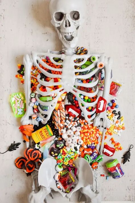 Picture of a candy table styled with a skeleton is a perfect solution for Halloween, you can offer sweets to your guests this way Halloween Candy Table Ideas, Candy Table Ideas, Halloween Candy Table, Candy Charcuterie, Party Theme Ideas, Vampire Teeth, The Bayou, Halloween 20, A Skeleton