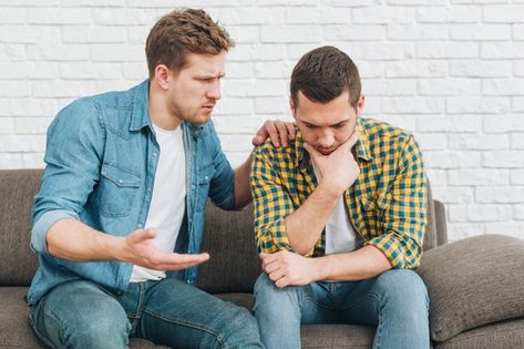 Portrait of a young man comforting his sad friend sitting on sofa Photo | Free Download Guy Friend, Thumbs Up Sign, Talking On The Phone, Women Talk, Family Cartoon, How To Talk, Guy Friends, Man Sitting, Online Student