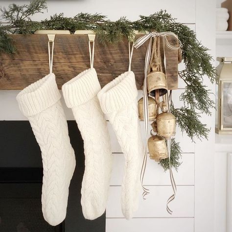 Christmas mantel with reclaimed wood beam, shiplap, harmony bells, knit stockings, and cedar garland. The Coastal Oak. Minimal Christmas, Christmas Mantle, White Christmas Decor, Natural Christmas, Christmas Inspo, Boho Christmas, Christmas Mantels, Holiday Stockings, Farmhouse Christmas Decor