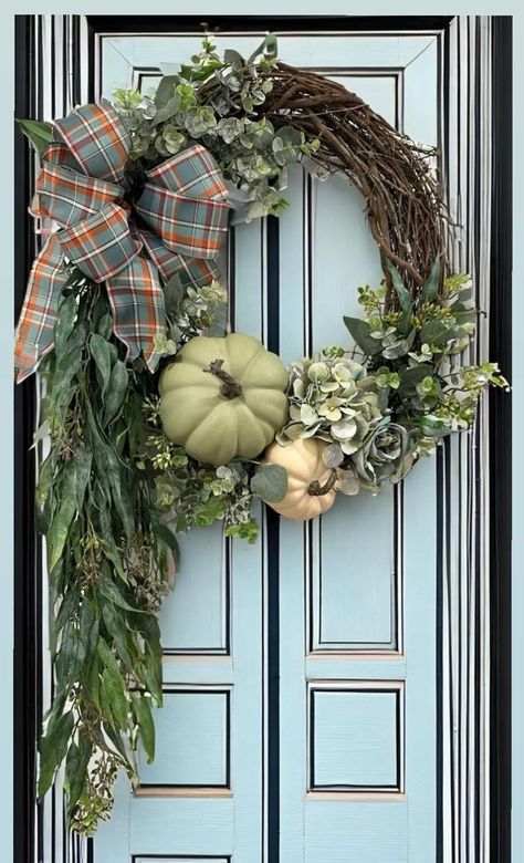 This Sage green stylish wreath features soft green hydrangeas, roses, and a creamy white and green pumpkins upon a soft bed of frosted eucalyptus stems with complimenting eucalyptus garland that hangs aprox. 20" on one side. Great for Thanksgiving Decor inside or outside! Supplies Mary vary with availability. Green Pumpkins, Frosted Eucalyptus, Eucalyptus Stems, Harvest Wreath, Eucalyptus Garland, Soft Bed, Fall Front Door, Green Hydrangea, Diy Fall Wreath