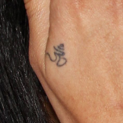 Zoë Kravitz Om Back of Hand Tattoo | Steal Her Style Tattoos Zoe Kravitz, Zoe Kravitz Tattoos, Back Of Hand Tattoos, Ohm Tattoo, Ohm Symbol, Father Tattoos, Secret Tattoo, Small Tats, Finger Tattoo Designs