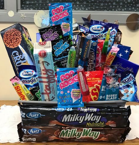 A Universe of Stories Summer Reading Program Space themed candy basket Space Candy Ideas, Space Themed Fundraiser, Space Themed Candy Bar, Space Themed Gift Basket, Space Theme Gifts, Space Candy Table, Space Goodie Bags, Space Themed Candy, Space Theme Food