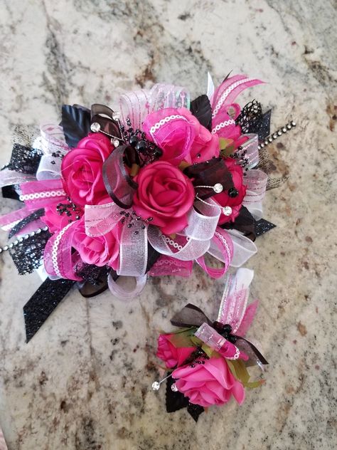 Fuschia Wrist Corsage, Homecoming Corsage And Boutonniere Pink, Hot Pink And Black Corsage Prom, Pink And Black Boutonniere, Black And Pink Corsage And Boutonniere, Black And Pink Prom Look, Prom Corsage And Boutonniere Pink, Hot Pink And Black Corsage, Fuschia Corsage