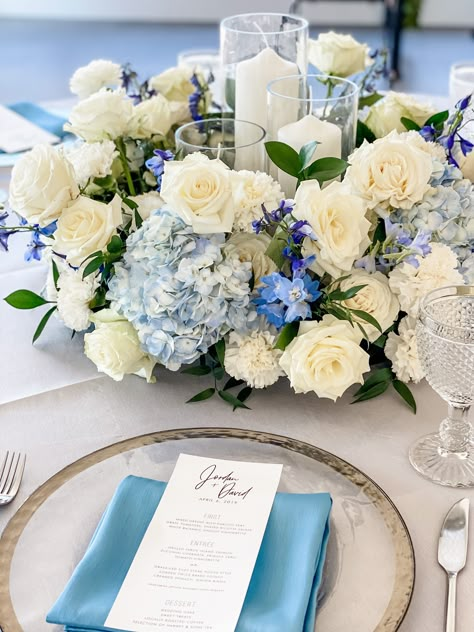 Blue Theme Wedding Centerpieces, Blue And White Flower Centrepiece, White Blue Hydrangea Centerpiece, Tall Blue Floral Centerpieces, Navy Blue And Light Pink Wedding Centerpieces, Blue And White Roses Centerpieces, Blue Carnation Centerpieces, White Roses And Blue Hydrangeas Centerpiece, Navy Blue Hydrangea Wedding