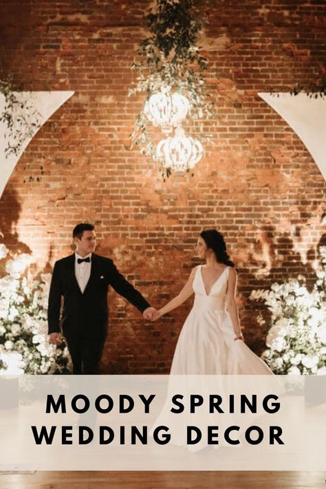 How stunning is this moody spring wedding decor at our industrial Tennessee venue? Backlights and chandeliers are great lighting options to create a moody ambience versus standard overhead lighting. To keep the wedding with the spring season, decorate with bright, fresh florals. Check out out blog for more moody spring wedding decor! Spring Indoor Wedding, Indoor Wedding Ceremony Decor, Moody Spring Wedding, Wedding Ceremony Decor Ideas, Ceremony Decor Ideas, Spring Wedding Decor, Indoor Wedding Ceremony, Romantic Ceremony, Industrial Chic Wedding