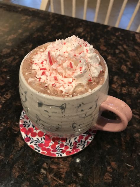 Peppermint Hot Chocolate! You'll need Swiss Miss powder, whipped cream, and a candy cane. First, heat up some boiling water and add in one packet of mix. Second, break the candy can in half and let it melt in the cocoa. Third, put the other half of the candy cane in a plastic bag and smash it with a mallet or a spoon. Finally, add whipped cream and add the smashed candy cane pieces on top. Enjoy! Swiss Miss, Peppermint Hot Chocolate, The Other Half, Other Half, Boiling Water, Christmas Treats, Hot Cocoa, Whipped Cream, Plastic Bag