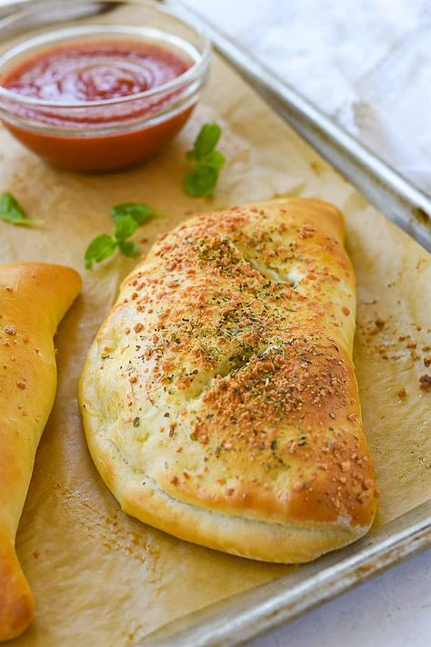 A calzone is a stuffed pizza pocket that you can fill with your favorite pizza toppings. They are the perfect prep ahead meal because they freeze and reheat well. Can You Freeze Pizza Dough, Sourdough Pizza Pockets, Calzones With Pizza Dough Pillsbury, Calzones With Pizza Dough, Calzone Dough Recipe, Easy Calzone Recipe, Easy Calzone, Calzone Recipes, Calzone Dough