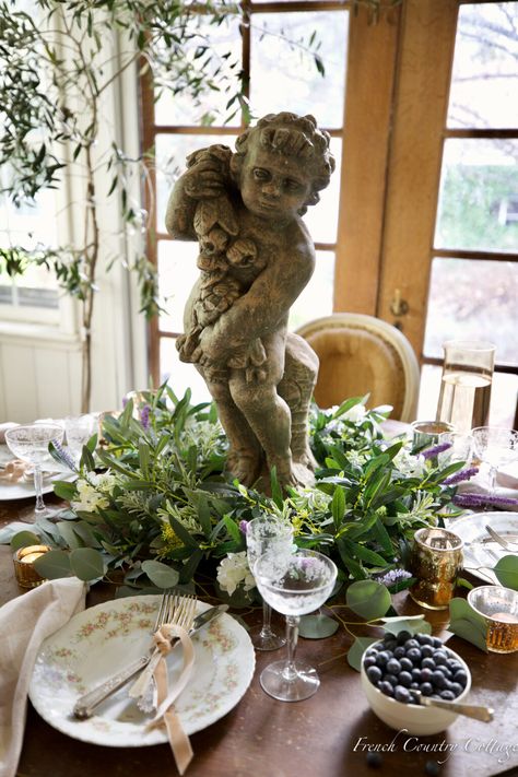 Spring Table Centerpiece with garden statue - French Country Cottage Spring Table Centerpieces, Potted Olive Tree, French Country Table, Springtime In Paris, French Vintage Decor, Spring Basket, Country Table, Small Wreaths, Beautiful Table Settings