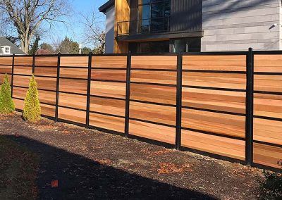 Wood And Metal Fencing Ideas, Steel Fence Design Modern, Custom Fence Ideas, Wood Fence With Black Posts, Black Cedar Fence, Black Metal And Wood Fence, Black And Cedar Fence, Modern Cedar Fence, Horizontal Wood Fence With Metal Posts