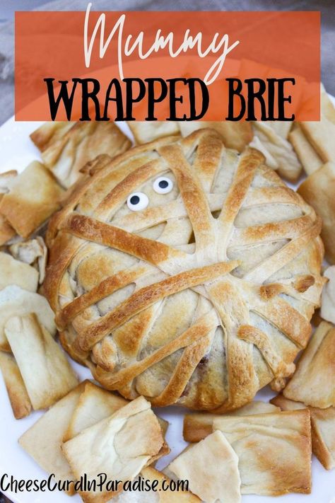 Brie wrapped in puff pastry and baked Mummy Wrapped Brie, Mummy Baked Brie Halloween, Mummy Brie Cheese, Mummy Baked Brie, Halloween Brie, Mummy Brie, Wrapped Brie, Holiday Themed Desserts, Cheese Curd