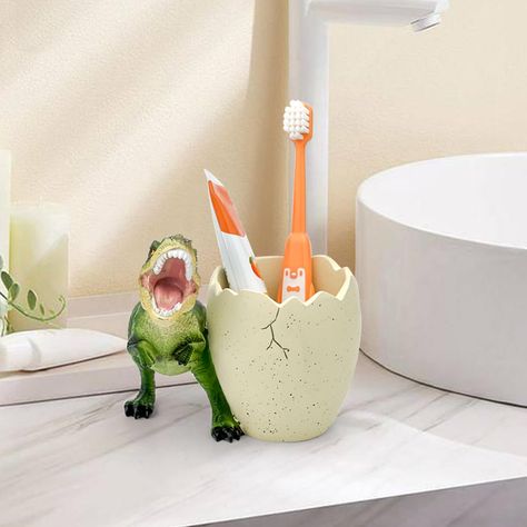 PRICES MAY VARY. ❥【Make Brushing Teeth Fun with a Cute Dinosaurs】your kids will love this adorable dinosaurs toothbrush holder that adds a touch of whimsy to their sink. it will encourage them to brush their teeth regularly and enjoy their dental hygiene. This cute dinosaurs toothbrush holder is the best gift for the child to attract their attention and cultivate a good habit of brushing. PLEASE RECOGNIZE THE FlidRunest BRAND AND PATENT! ❥【Easy to Clean】Kids Dinosaur Toothbrush Holders are easy Kids Bathroom Shelves, Dinosaur Themed Bathroom, Dinosaur Bathroom Ideas, Dino Bathroom, Dinosaur Toothbrush Holder, Kids Toothbrush Holder, Dinosaur Bathroom, Toothbrush Organizer, Kid Bathroom