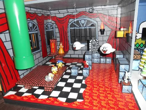 Close up of the castle, the stomper can go up and down and also the door lowers to become a walk way to save the princess. #Mario castle Bowsers Castle Decoration, Bowsers Castle Diy, Mario Shelves, Mario Dollhouse, Mario Playhouse, Mario Castle, Mario House, Bowser Castle, Mario Bros Room