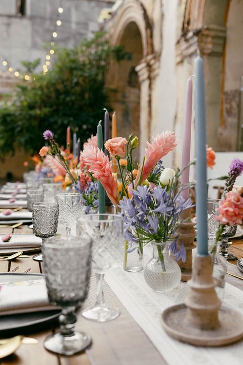 Pastel colorful reception table with vibrant florals and taper candles #pastelwedding #colorfulwedding #pastelcandles #pastelflorals #colorfulflorals Colored Candlesticks, Colorful Reception, Marquee Decor, Taper Candles Wedding, Colored Taper Candles, Pastel Candle, Long Table Wedding, Wedding Candles Table, Vibrant Florals