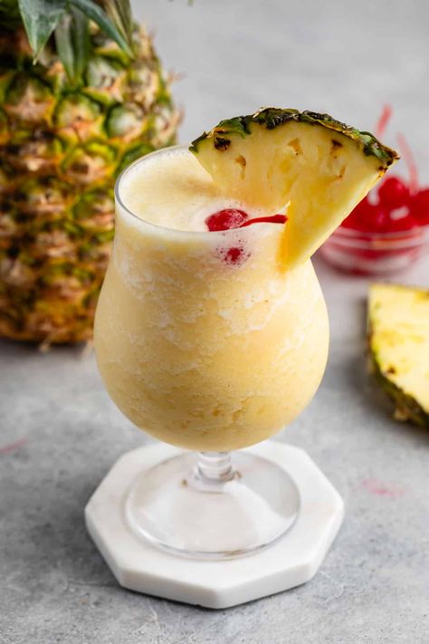 This Virgin Pina Colada will make you think you're on vacation - it's creamy and frozen and so good - and it's a non-alcoholic version. Popular Summer Drinks, Pina Colada Mocktail, Frozen Pina Colada, Virgin Pina Colada, Cream Of Coconut, Pina Colada Recipe, Alcohol Free Drinks, Fresh Fruit Juice, Frozen Cocktails