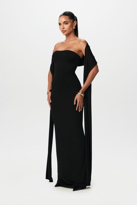 Simplicity meets sophistication in our vacay-inspired set. Designed with a tube and double-lined bodycon structure with a detachable scarf to wrap around your head or relax along your arms. Smooth Collection Import 92% Viscose Rayon, 8% Spandex Model wears size X-Small True to size Double-lined Corset Tie Back Dress, Classy Black Dress Black Women, Black Long Elegant Dress, All Black Wedding Aesthetic, Black Backless Dress Classy, Prom Dresses With Scarf, Winter Gowns Formal, How To Style A Scarf With A Dress, Winter Dress Outfit Party