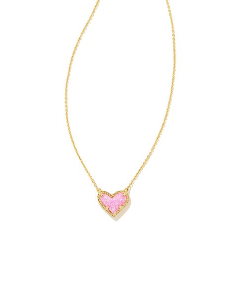 Feminine yet flirty with an asymmetrical design, the Ari Heart Gold Pendant Necklace in Bubblegum Pink Kyocera Opal is our new obsession. Layer it or let it shine on its own—either way you'll be hearing "Where'd you get that?" every time you wear this pendant necklace out. Metal 14k Yellow Gold Over Brass Material Bubblegum Pink Kyocera Opal Closure Lobster Clasp Size 15" chain w/ 2" extender, 0.57"L X 0.49"W pendantDue to the one-of-a-kind nature of the medium, exact colors and patterns may var Heart Pendant Necklace Gold, Short Pendant Necklace, New Obsession, Kendra Scott Necklace, Let It Shine, Asymmetrical Design, Shine On, Stunning Necklace, Short Necklace