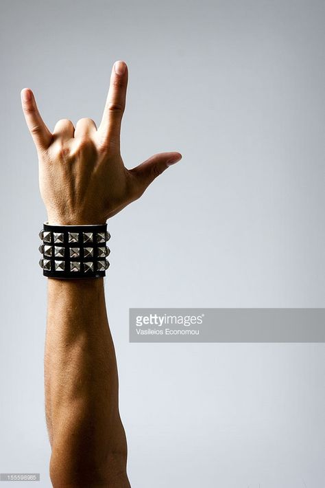 Stock Photo : Man in Wristband making Rock & Roll Hand Symbol Rock Symbol, Rock Hand Sign, Hand Gesture Drawing, Rock Sign, Hand Symbols, Male Pose Reference, Hand Photography, Rock Hand, Hand Drawing Reference