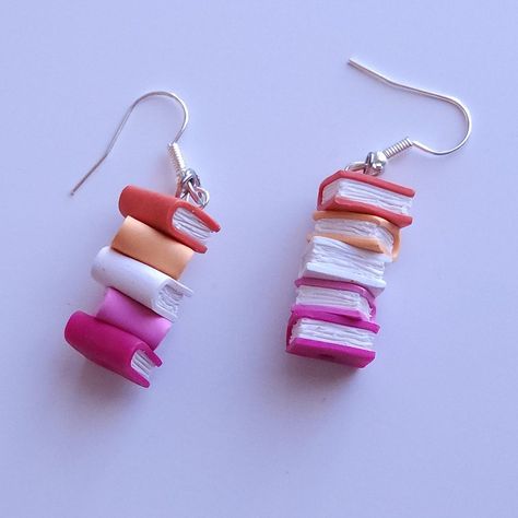 SHOP THE PRIDE COLLECTION: https://www.etsy.com/shop/MadHatterJewelryCo?ref=shop-header-name&listing_id=1717997200&from_page=listing§ion_id=49219597 Subtly show off your pride with these book earrings that match the colors of the lesbian flag ♥ Perfect for book lovers as well as members and allies of the LGBTQIA+ community for pride month or all year round! Details: ♥ Handmade ♥ Hardware can be gold or silver ♥ Comes with plastic earring backing My earrings are made to order. Because of that, th Pride Products, Modelling Clay Earrings, Cute Earring Ideas, Lesbian Earrings, Diy Earrings Clay, Funky Earrings Diy, Pride Earrings, Weird Earrings Aesthetic, Weird Earrings