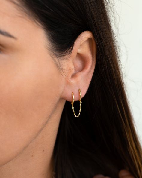 "Two dainty huggie hoops are connected by a delicate chain in this double piercing earring design. Dress it up or down, this simple double huggie hoop earring is perfect to add some layering to your ear stack. ♦ Sold singly (1 piece) or as a pair (2 pieces). * D E T A I L S * ∙ Material: .925 Sterling Silver or 18K Gold Plated over .925 Sterling Silver  ∙ Inner diameter: 9mm     Chain length: 2.5cm ∙ Hypoallergenic & nickel-free * P A C K A G I N G * ∙ All jewelry is sent out beautifully package 2nd Ear Piercing, 3 Lobe Piercings, Double Piercing Earring, Piercing Lobe, Tiny Gold Earrings, Double Ear Piercings, Ear Lobe Piercings, Double Earrings, Huggie Earrings Gold