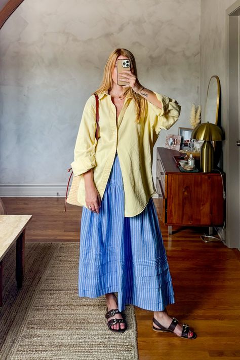 Big shirt, big skirt is my vibe for summer. I love this Dôen sebastian skirt in blue stripe, it is so soft and comfortable. I paired this midi skirt with a vintage men's oversized button down and stuck with blue and yellow for color blocking. This is an easy summer outfit that is chic and perfect for lunch dates or running to the farmers market. #coastalaesthetic #europeansummeraesthetic #sezanelovers • European summer outfits • french girl fashion • casual chic outfit ideas • butter yellow • Oversized Shirt And Midi Skirt Outfit, Doen Sebastian Skirt, Collared Button Up Shirt Outfit, Blue Striped Outfit, Full Coverage Summer Outfit, Long Skirt Button Up Shirt, How To Style Blue Skirt, Button Down Shirt Over Dress Outfit, Button Up Shirt Skirt Outfit