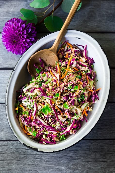 Easy Crunchy Asian Slaw- a simple vegan slaw with the BEST SLAW DRESSING EVER that can be made ahead! Serve this alongside fish, tofu, or chicken or stuffed into tacos, topped onto burgers, or added to buddha bowls. A great way to add more veggies into your everyday meals. #slaw #asianslaw #veganslaw #easyslaw #tacoslaw Asian Slaw Dressing, Vegan Slaw, Feasting At Home, Asian Dressing, Vegan Coleslaw, Slaw Dressing, Asian Slaw, Vegetarian Cabbage, Slaw Recipes