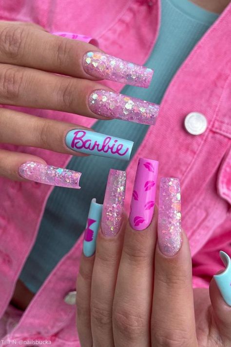 This post is about barbiecore nail designs! Barbiecore nails focus on all things Barbie inspired, and there are SO many fun pink nail ideas that come from this manicure style. Barbiecore nails include lots of light, medium, and hot pink nail designs, Barbie nail silhouettes & logos, and tons of pink glitter nails with lots of flashy details to make your fun Barbie nails manicure pop and stand out. Acrylic Barbie Nails, Nail Designs Barbie, Barbie Movie Nails Design Ideas, Acrylic Nails Barbie, Barbie Pink Coffin Acrylic Nails, Barbie Nails With Charms, Barbie Pink And Blue Nails, Barbie Acrylic Nails Pink Glitter, Hot Pink Nail Designs