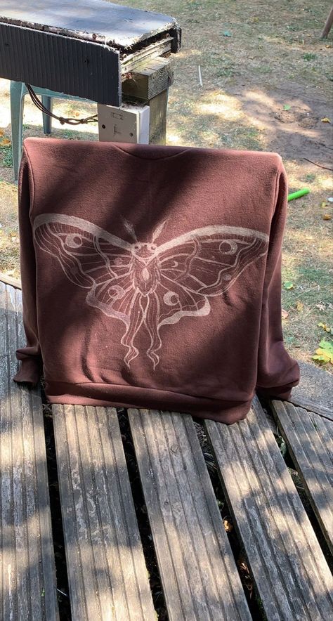 a brown hoodie with a bleached moth design on the back Bleach Moth Hoodie, Bleached Moth Shirt, Brown Bleached Shirt, Bleach Moth Shirt, Tshirts Design Ideas Creative, Moth Bleach Design, Bleach Painting Clothes Easy, Bleach Painted Sweatshirt, Painted Bleach Hoodie