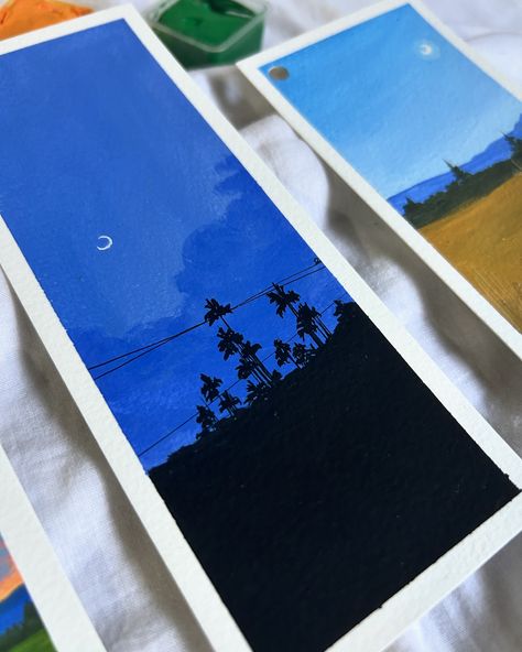 A serene trio of landscape bookmarks, painted with gouache, capturing the beauty of different times of day—from a vibrant sunset with lavender fields to a calm dusk with silhouetted palm trees, and a tranquil daytime countryside scene under a crescent moon. Used @cansonpaper bookmark sheets ❤️ @miyahimi.in gouache paints from @thoovi.arts [ gouache paints, easy book illustration, gouache artist, landscape painting, gouache art ] #gouache #gouachepainting #gouacheillustration #gouacheart #... Easy Books, Gouache Illustrations, Gouache Art, Lavender Fields, Gouache Painting, Book Illustration, Palm Trees, Art Lessons, Art Inspo