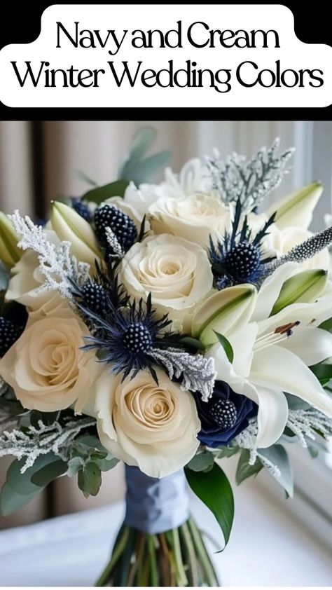 Elegant wedding bouquet with cream roses, white lilies, and navy blue thistles for a winter wedding. Navy Gold Wedding Flowers, Navy Centerpiece Wedding, Dark Blue Wedding Bouquet, Navy Blue Flowers Aesthetic, Winter Wedding Bouquet Blue, Navy Centerpieces, Wedding Colors Ideas, Winter Wedding Color Ideas, Cream Wedding Invitations