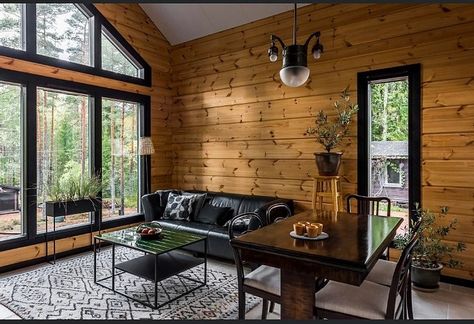 Log Cabin With Black Windows, Wood Walls With Black Trim, Black And Cedar Interior, Knotty Pine Walls With Black Trim, Cabin Walls Interior, Cabin Window Trim, Breezeway Makeover, Sunroom Transformation, Knotty Pine Living Room