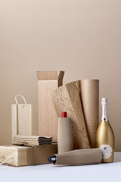 A selection of wooden bottle boxes and transit bottle boxes with corrugated bottle sleeves and bottles of wine, prosecco and champagne. Packaging Hampers, Cylindrical Objects, Wicker Hamper, Bottle Sleeves, Bottle Box, Christmas Packaging, Packaging Supplies, Shipping Boxes, Bottle Packaging