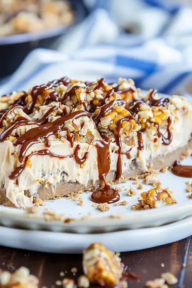 Explore our No-Bake Snickers Bar Pie to create a perfect blend of graham cracker, peanut butter, and chocolate. Dive into dessert making now. Graham Cracker Peanut Butter, Snickers Bar, Peanut Butter And Chocolate, Caramel Syrup, Whipped Cream Cheese, Chocolate Syrup, Graham Cracker Crust, Graham Cracker Crumbs, Graham Cracker