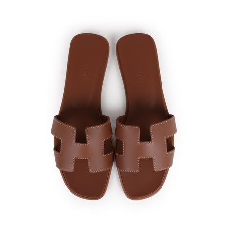 This pair of Oran Sandals are in Gold calfskin leather with contrast stitching, a natural leather insole and feature the iconic H crossover strap. Origin: ItalyCondition: New and never wornAccompanied by: Hermes box, dustbags, carebook and ribbonSize: 37.5 EU Sandals With Small Heel, Hermes Sandals Brown, Brown Hermes Sandals, Keffiyeh Aesthetic, Hermes Flats, Hermes Products, H Sandals, Hermes Sandal, Sandals Hermes