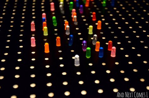 Close up of light bright pegs on a homemade light bright from And Next Comes L Light Bright Wall, Diy Bucket List, Diy Bucket, Lite Brite, Sensory Ideas, Bright Walls, Light Board, Dollar Store Organizing, Scrapbook Room