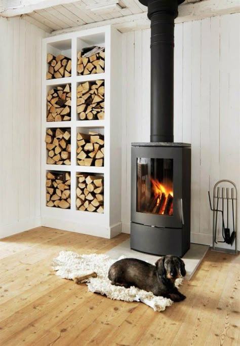 This stove is perfect for heating up a small space. Wood Stove Decor, Scandinavian Fireplace, Fireplace Options, Firewood Storage Indoor, Stove Decor, Design Camino, Wood Stove Fireplace, Firewood Rack, Firewood Storage