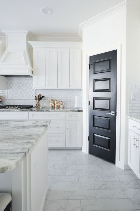 A gorgeous and bright white kitchen with shaker cabinets, fantasy brown granite and a stunning black pantry door. I LOVE the backsplash! Black Pantry Door, White Shaker Cabinet Kitchen, Black Pantry, White Shaker Cabinet, Beautiful White Kitchens, Black Interior Doors, White Shaker Kitchen, White Shaker Cabinets, Kitchen Remodel Inspiration