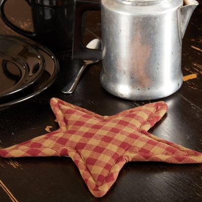 The 10” Rudd Star Trivet features alternating country colors for a primitive-style. Place the Star Trivet on your table for a true country addition to your home. This primitive trivet is lovingly quilted in alternating colors on 100% cotton. Use to protect your surfaces from heat, scuffs, or condensation while enjoying the natural texture of this pointed edge trivet. Color: Burgundy | August Grove® Rudd Coaster Cotton in Red, Size 1.0 H x 10.0 D in | Wayfair Modern Primitive Decor, Primitive Table, Modern Primitive, Primitive Stars, Primitive Star, Primitive Design, Vhc Brands, Vintage Farmhouse Style, Kitchen Table Decor