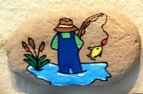 Painted Rock, Fisherman, Fishing, Bait and Hook, Sea Oats, Cat Tails, Yellow Fish, Overalls, Fishing Hat, Rod and Reel, Fishing Pole, Waders, Hooked, Water, Lake, Pond, Gone Fishin', #SSBMandi Painting Fish On Rocks Ideas, Fishing Rock Painting Ideas, Rock Painting Ideas Easy For Kids, Painting Pebbles, Rock Fish, Lake Theme, Painted Garden Rocks, Sea Oats, Cat Tails