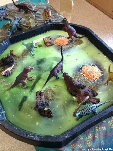 Dinosaur Sensory Swamp Tuff Tray Tuff Tray Dinosaurs, Swamp Sensory Bin, Animal Tuff Tray Ideas Eyfs, Tuff Tray Ideas For Under 2s, Eyfs Activities For Under 2s, Animal Tuff Tray Ideas, Animal Tuff Tray, Baby Tuff Tray Ideas, Nursery Tuff Tray Ideas