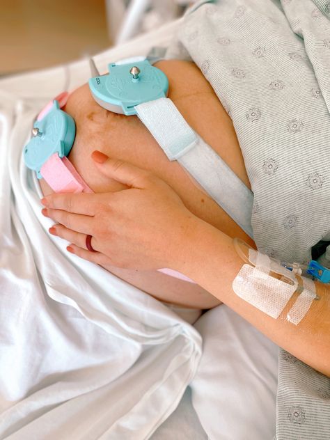 Pregnant woman’s belly with baby monitor strapped around body (pink and blue straps). Woman’s hand is holding belly. Maternity Hospital, Pregnancy Photos, How To Plan