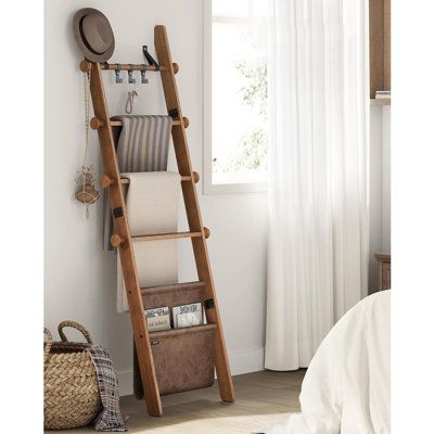 Transform your living space with this blanket ladder. This 5-tier ladder shelf features 4 hanging rods perfect for displaying towels, blankets, or sheets, and a bottom synthetic leather bag for clothes, decor, or other items. Keep your living room or bedroom clean and organized while adding a stylish touch to your home decor. | One Allium Way 5-Tier Decorative Farmhouse Blanket Rack w/ Synthetic Leather Bag, Metal Hooks, Side Hooks Brown | C111811278_403191563 | Wayfair Canada Hanging Blanket Ladder, Blanket Ladder Modern Farmhouse, Industrial Farmhouse Blanket Ladder, Farmhouse Blanket Latter, Blanket Ladder Decor, Dark Brown Blanket Ladder, Antique Ladder Blanket Holder, Wood Blanket Ladder, Wooden Ladder Shelf